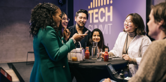 Group of colleagues conversing at a technology summit