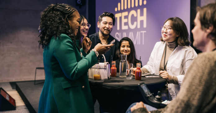 Group of colleagues conversing at a technology summit