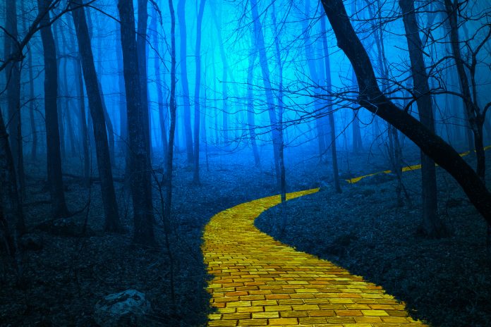 A yellow brick road through a forest